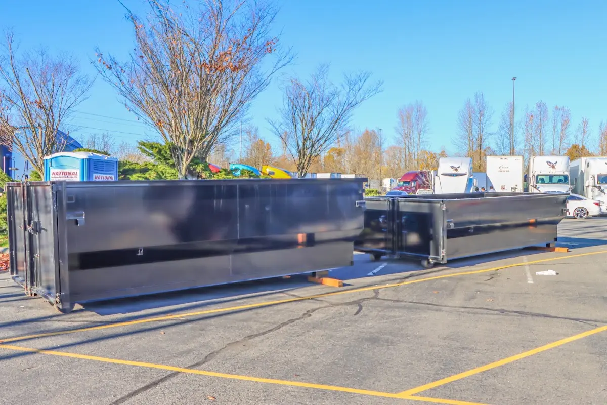 Professional dumpster rental service with roll-off container on residential driveway in Ashburn